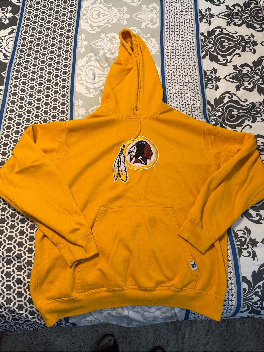 Gold Hooded Sweatshirt with Embroidered Native-Inspired Emblem